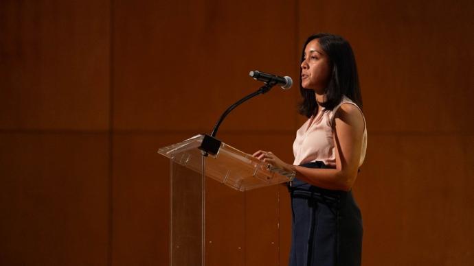 Nadia Islam speaks at a podium